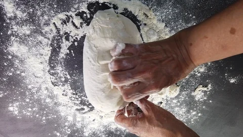 Baker kneading dough in flour on table Stock Footage 113093281