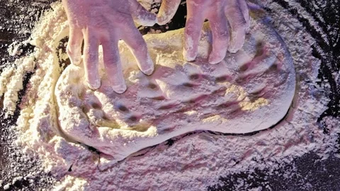 Baker kneading dough in flour on table Stock Footage 170232918