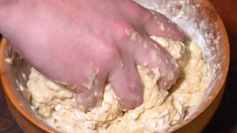 Baker kneading dough in flour on table. Stock Footage 249512704