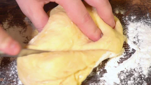 Baker kneading dough in flour on table. Stockbeeldmateriaal 250442118