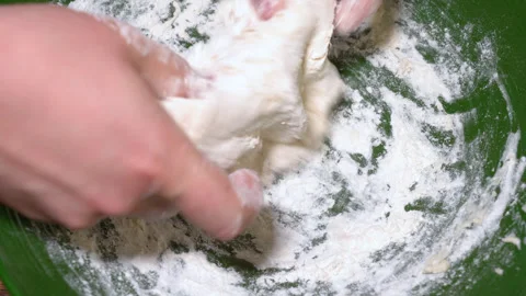 Baker kneading dough in flour on table. Stock Footage 252460132