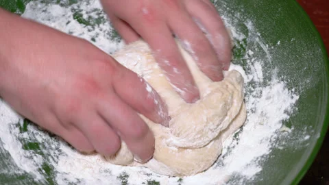 Baker kneading dough in flour on table. Stock Footage 252460914