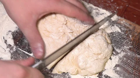 Baker kneading dough in flour on table. Stock Footage 254168294