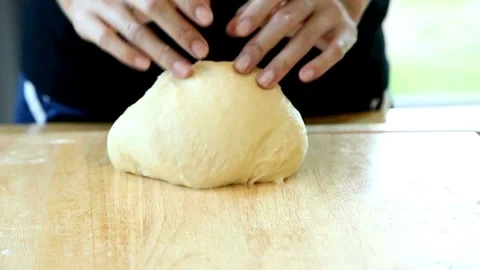 Baker kneading dough in flour on table making homemade bread close up 4k fr.. Stock Footage 272469697