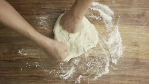 Baker kneading dough in flour on table making homemade bread close up 4k fr.. Stock Footage 272469775