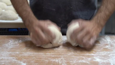 Baker kneading dough in flour on table making homemade bread close up 4k fr.. Stock Footage 272469839
