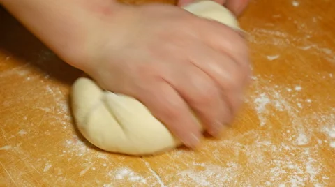 Baker kneading dough with hand on table in flour Stock Footage 61197295
