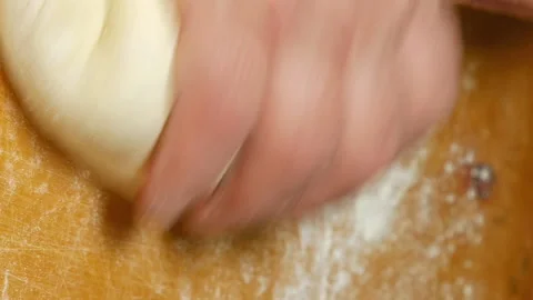 Baker kneading dough with hand on table in flour Stock Footage 91164780