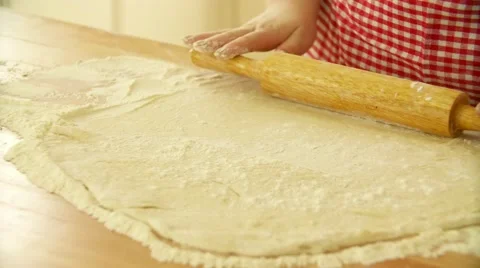 Baker kneading dough with rolling pin on table. Woman rolling dough for pizza Stock Footage 69063328