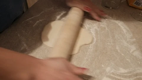 Baker kneading dough with rolling pin on table Stockbeeldmateriaal 86359400