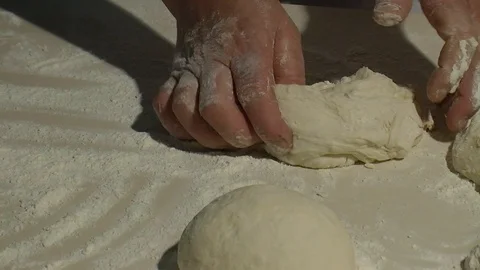 Baker kneading dough with rolling pin on table. Woman rolling dough for pizza. R Stock Footage 90688115