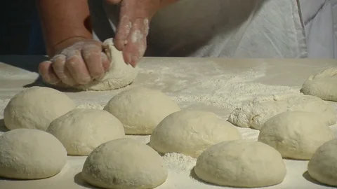 Baker kneading dough with rolling pin on table. Woman rolling dough for pizza. Stock Footage 90688728