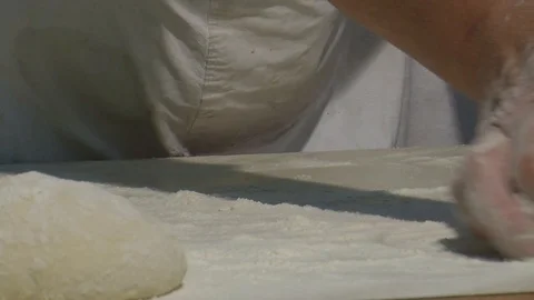 Baker kneading dough with rolling pin on table. Woman rolling dough for pizza. Stock Footage 90720996