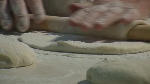 Baker kneading dough with rolling pin on table. Woman rolling dough for pizza. 動画素材 90721950
