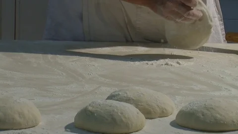Baker kneading dough with rolling pin on table. Woman rolling dough for pizza. Stock Footage 90722034