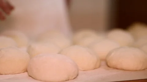 Baker kneading dough with rolling pin on table. Woman rolling dough for pizza. R Stock Footage 90731768