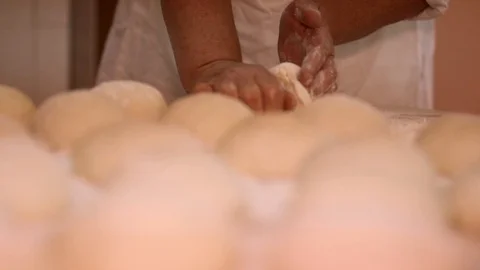 Baker kneading dough with rolling pin on table. Woman rolling dough for pizza. R Stock Footage 90731975