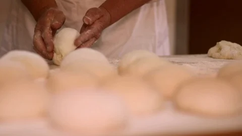 Baker kneading dough with rolling pin on table. Woman rolling dough for pizza. R Stock Footage 90732143