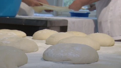 Baker kneading dough with rolling pin on table. Woman rolling dough for pizza. R Stock Footage 90732280