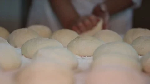 Baker kneading dough with rolling pin on table. Woman rolling dough for pizza. R Stock Footage 90732386