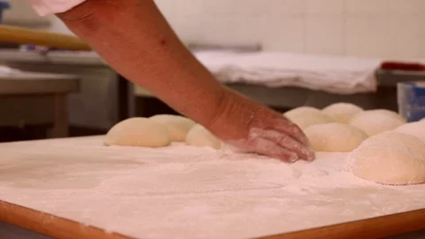 Baker kneading dough with rolling pin on table. Woman rolling dough for pizza. Stock Footage 90733401