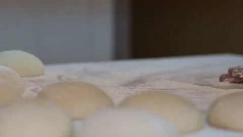 Baker kneading dough with rolling pin on table. Woman rolling dough for pizza. Stock Footage 90733547