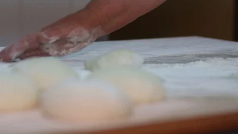 Baker kneading dough with rolling pin on table. Woman rolling dough for pizza. Stock Footage 90734030