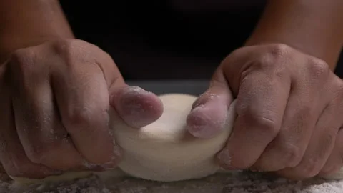 Baker kneading dough on table, Close-up and slow motion Stock Footage 132678896