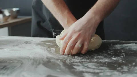 Baker Kneading Dough on Table Vidéo 168894444
