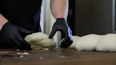 Baker kneads and shapes bread from dough. Stock Footage 313531848