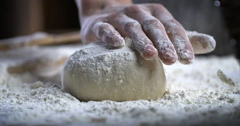 Baker kneads dough with flour while making bread or pizza in bakery kitchen. Stock Footage 269331795