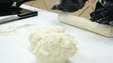 The baker kneads the dough on the table. Video stock 171851938