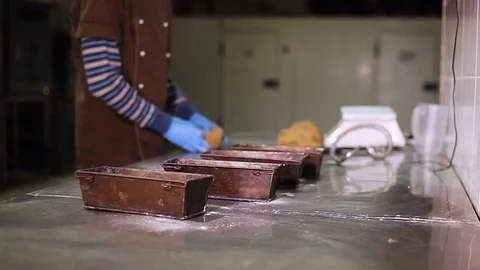 Baker lays out the dough for bread in the bakeware Stock Footage 106460922