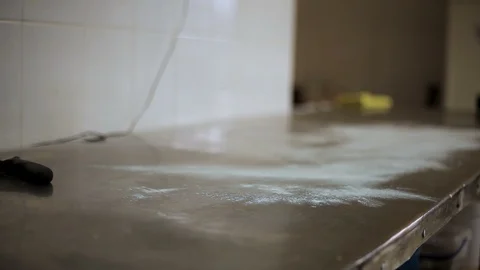 Baker lays on the table a huge piece of dough from a rolling pin Stock Footage 106467724
