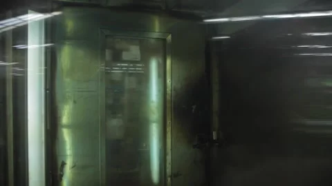 Baker loads a rack of cakes into an large oven Stock Footage 231414741