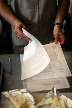 The baker looks through the recipe. Problem Stock Photos