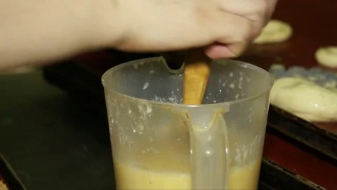 A baker lubricates the buns and sprinkle them dusting Video stock 71816307