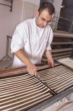 Baker makes the bread sticks Stock Photos