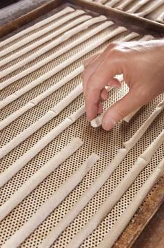 Baker makes the bread sticks Stock Photos