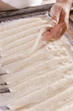 Baker makes the bread sticks Stock Photos