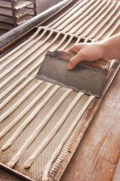 Baker makes the bread sticks Stock Photos