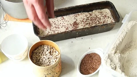 Baker makes bread, sunflower seeds dough Stock Footage 78177876