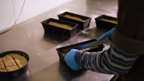 The Baker makes cuts with a serrated knife on a bread dough Stockbeeldmateriaal 106461629