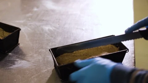 The Baker makes cuts with a serrated knife on the dough in bakeware Video stock 106482636