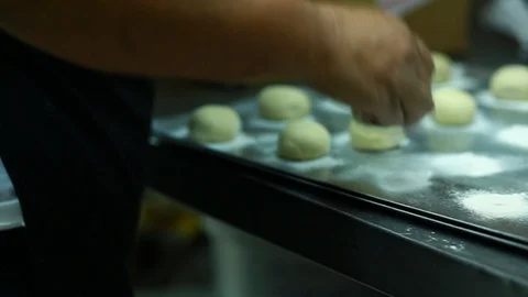 Baker makes deep-dried Sufganiyah for the Jewish festival of Hanukkah. Видео 116411739