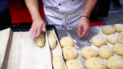 The baker makes handmade buns Stock Footage 232578368