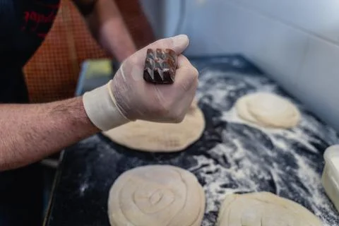 Baker makes pattern on blank for Uzbek flatbread Stock Photos