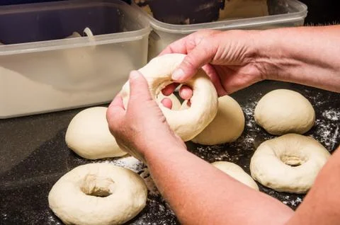Baker making bagels from dough 写真素材