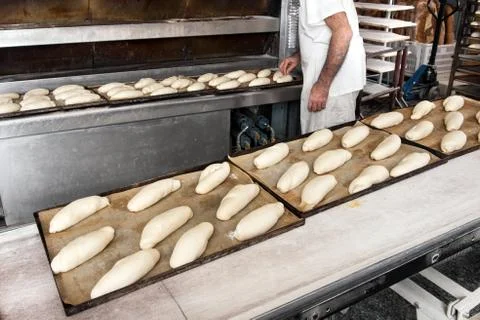 Baker making bread in bakery Stock Photos