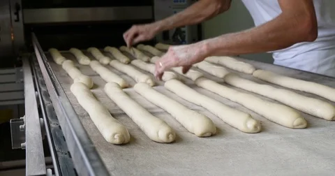 Baker making bread cooking industrial oven organic baguette whole grain Video stock 83998199